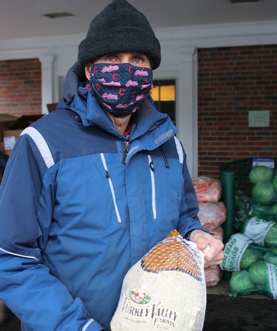 man donating food to food pantry